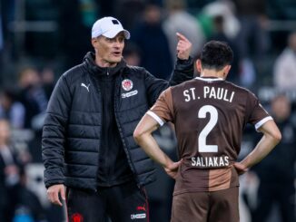 St. Paulis Manolis Saliakas (r) im Gespräch mit Trainer Alexander Blessin. Im Testspiel bei Eintracht Braunschweig erzielt der Abwehrspieler ein Eigentor.